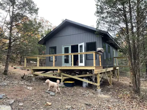 The elevated cabin on its 7-foot posts among the cedars